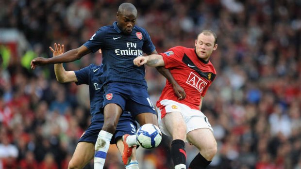 Former Arsenal man William Gallas beats Wayne Rooney to the ball in 2009.