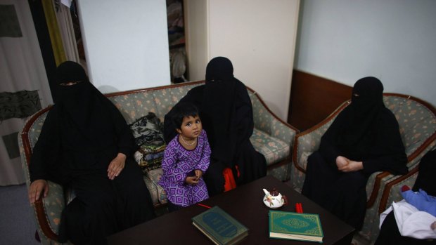 Uighur refugees wait during an interview with Reuters in Istanbul,Turkey, in July.