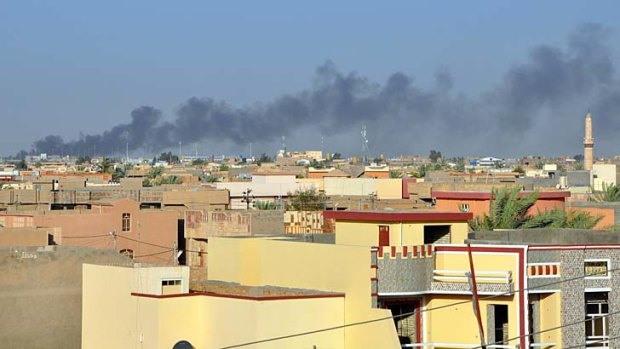 Smoke rises from buildings after shelling on the Iraqi city of Fallujah, west of the capital Baghdad, which has been held by anti-government fighters for more than four months.