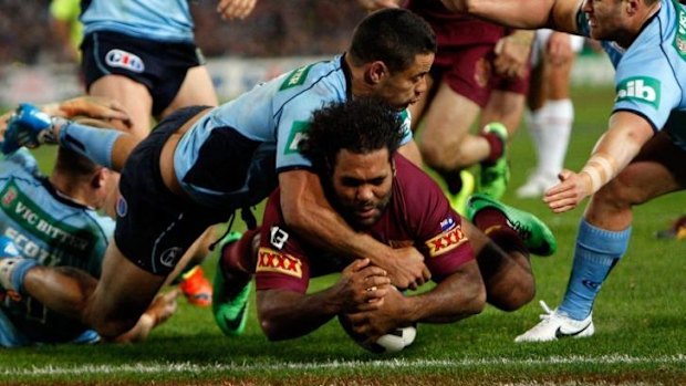 Clutch play: Hayne denies Sam Thaiday a try in Origin II.