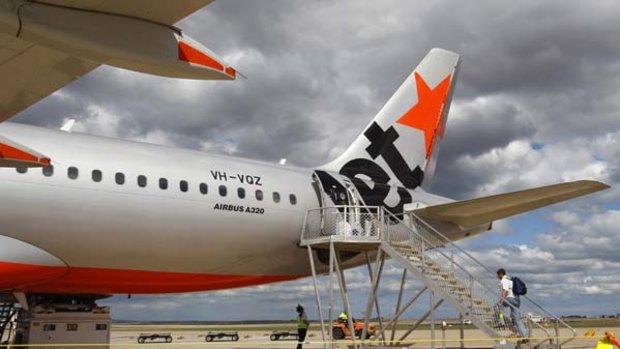 Jetstar says it will review its policies after a grieving family was charged to change its flights.