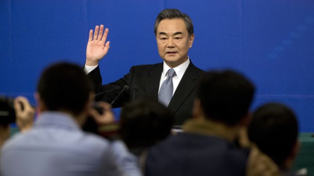 Wang Yi arrives at a press conference in Beijing on Sunday.