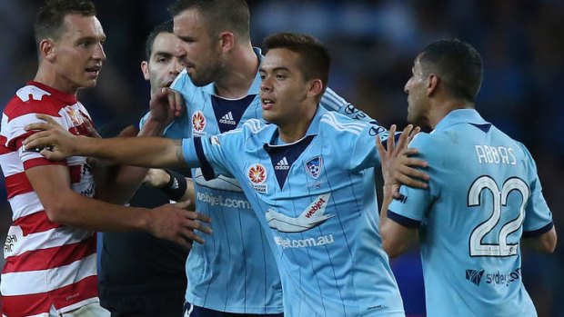 Angry words: Hagi Gligor places himself between Sydney FC teammate Ali Abbas and Brendon Santalab of the Wanderers  at Allianz Stadium on Saturday.
