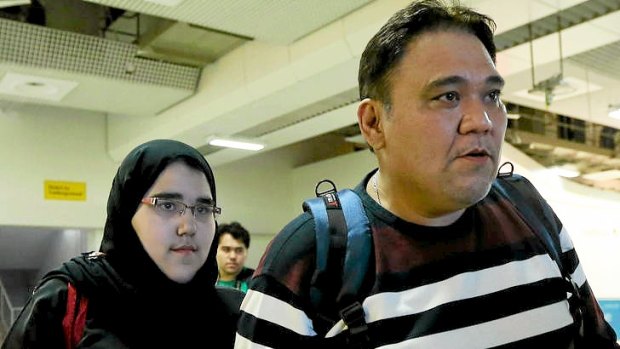 Saudi judo competitor Wojdan Shaherkhani (left) arrives with her father at Heathrow airport in preparation for the London Olympics.