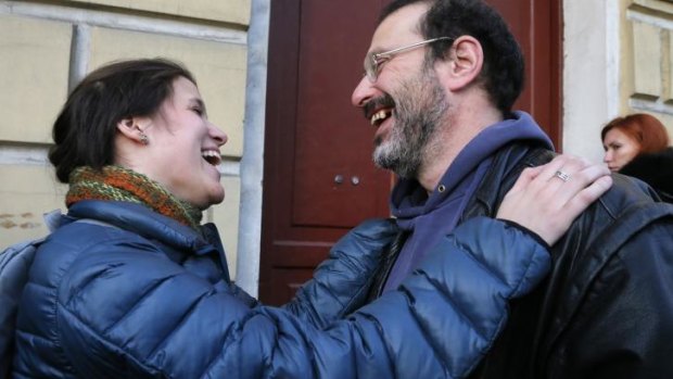 Greenpeace International activists, Camila Speziale of Argentina, left, and Dima Litvinov of Sweden embrace near the Federal Migration Service in St Petersburg, Russia.