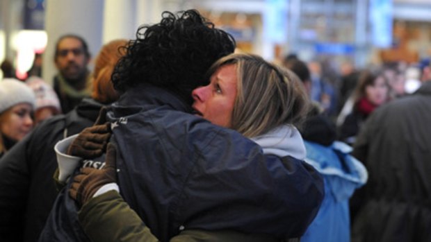 A Eurostar staff member comforts a passenger at London's St Pancras Station after long delays.