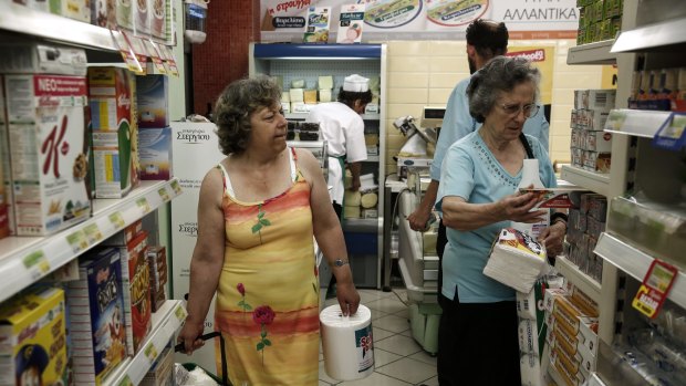 Facing long lines ... Customers shop for food products at a local supermarket in Athens, Greece.