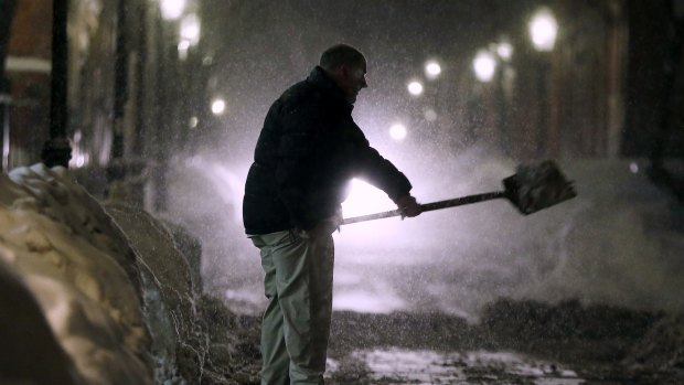 A man shovels snow on Beacon Hill in Boston on Saturday. 