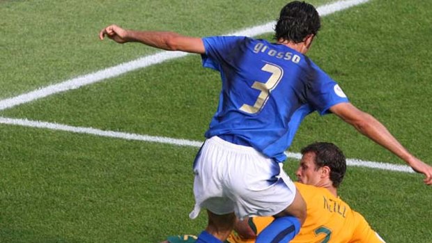 Fabio Grosso goes down after a challenge by Lucas Neill during the 2006 World Cup.