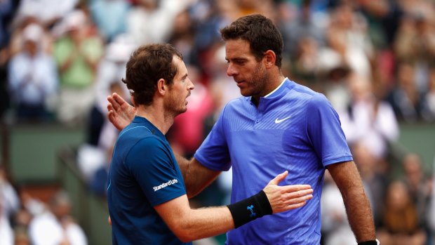 Andy Murray and Juan Martin Del Potro embrace after the men's singles third round match during day seven of the French Open.