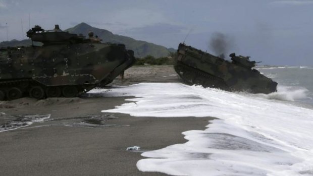 US Navy amphibious assault vehicles roll into the water facing the South China Sea in a joint naval exercise with the Phillipines on Monday, June 30.