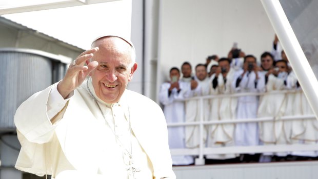 Pope Francis waves while arriving at the Bicentenario Park to celebrate Mass in Quito, Ecuador.