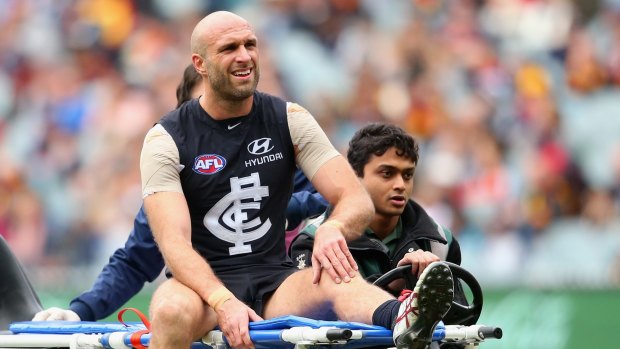 Chris Judd leaves the field after suffering a career-ending knee injury.