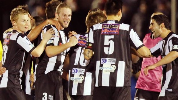 Jubilation: Adelaide City players celebrate their late goal that eliminated the Western Sydney Wanderers.