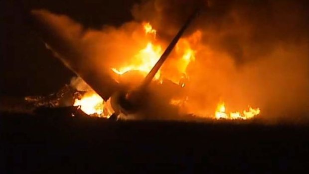 Flames rise from a UPS Airbus A300 cargo plane which crashed near the airport in Birmingham, Alabama.
