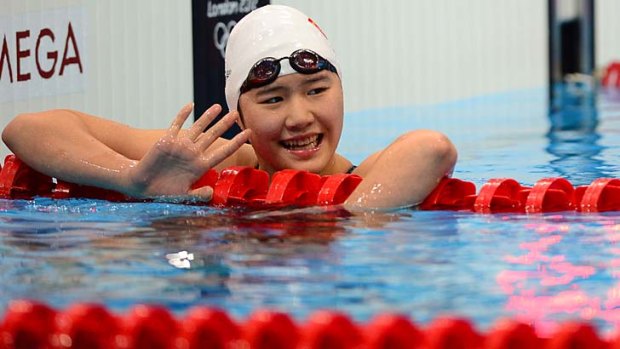 Golden grin ... but the stunning times of China's Ye Shiwen have aroused suspicion.