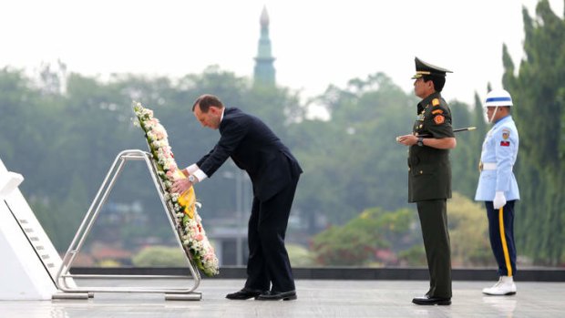 Calm: Australian Prime Minister Tony Abbott lays a wreath at Kalibata's Heroes Cemetery.