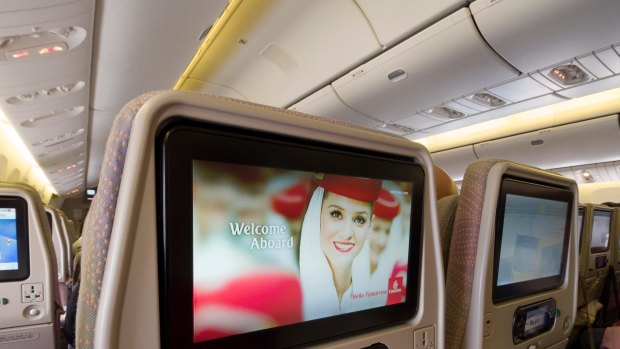 Entertainment system screens inside the cabin of a Emirates Boeing 777.