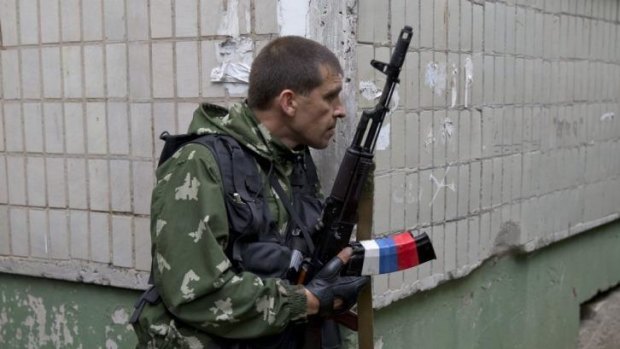 A pro-Russian holds his weapon during clashes with Ukrainian troops on the outskirts of Luhansk.