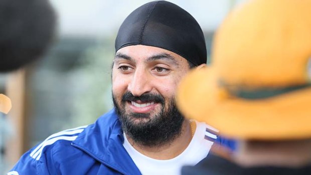 Monty Panesar signs autographs for fans at the MCG on Monday.