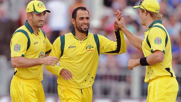 No logo: Fawad Ahmed (C) celebrating with teammates Shaun Marsh (L) and Shane Watson (R) during the Twenty20 international against England.