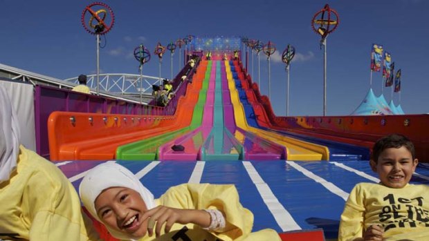 The fun continues on the way back up &#8230; pupils from Auburn Public School give the new Super Slide a test ride yesterday. The Royal Easter Show opens today.