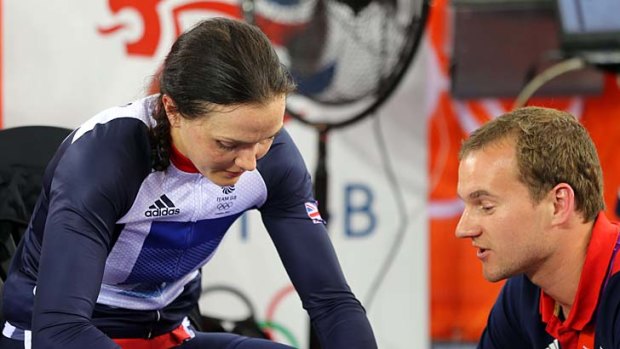 Consoled ... Victoria Pendleton is comforted by a member of her coaching staff.
