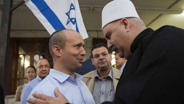 Campaigning ... Naftali Bennett, left, of the Jewish Home party speaks with a member of the Druze community in Israel.