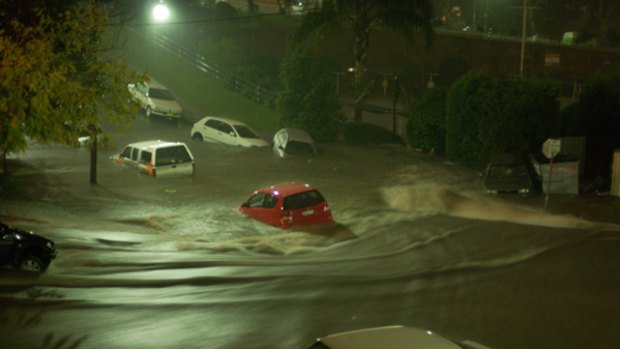 Cars floating down a flooded Dolphin Street, Coogee, on the evening of Saturday May 2.