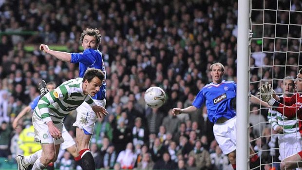 Jan Vennegoor of Hesselink scores the winning goal for Celtic against Rangers during a Scottish Premier League match in 2008.