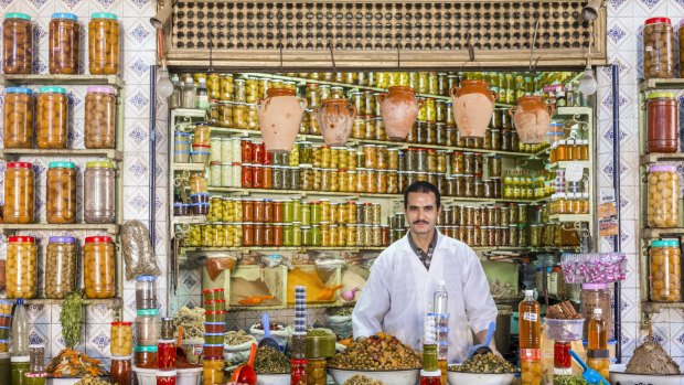 Souk El Khir, merchant of olives, vegetables and jars of condiments in Morocco.
