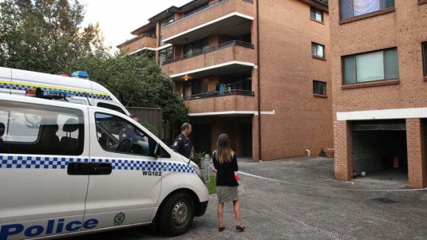 Body in the boot mystery: police outside the home of the dead woman.
