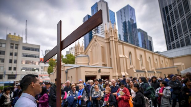 Some of the estimated 2000 people who attended the Stations of the Cross walk through Melbourne's CBD on Good Friday.