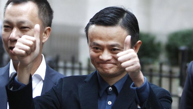 Alibaba founder Jack Ma poses for photographers outside the New York Stock Exchange.