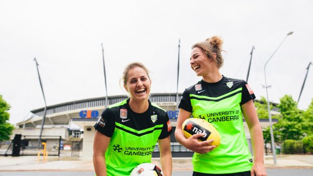 Canberra United players Ellie Brush and Jenna McCormick outside Canberra Stadium.