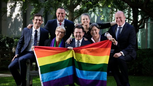 L-R: Trevor Evans, Janet Rice, Tim Wilson, Dean Smith, Louise Pratt, Penny Wong and Trent Zimmerman pose for a photo ahead of the vote on the Marriage Amendment Bill, at Parliament House in Canberra on Thursday 7 December 2017. fedpol Photo: Alex Ellinghausen (Please check with Bevan Shields before using photo)