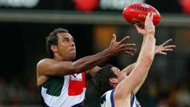 Roger Hayden of the Dockers and Nathan Grima of the Kangaroos contest a mark.