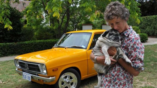 Janey Wallace at her home in Reid with her pet pug Oscar and her late son (Lachlan's) car.