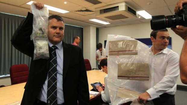 Detective Acting Superintendent Scott Knowles, left, shows drugs that were seized during a police raid at Surfers Paradise.
