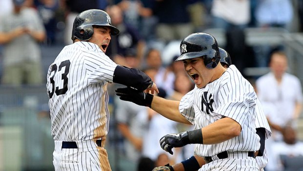 Russell Martin of the New York Yankees is congratulated by teammate Nick Swisher on his home run.