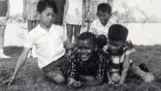 Happier days ... Barack Obama, centre, aged about 10 and then known as Barry Soetoro, at a classmate’s birthday party in Jakarta in 1971.