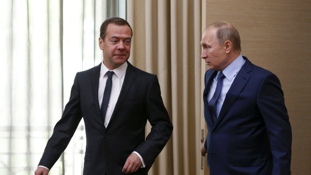 Russian President Vladimir Putin, right, and Prime Minister Dmitry Medvedev speak before a meeting of the Council for Strategic Development and Priority Projects in the Novo-Ogaryovo residence outside Moscow.