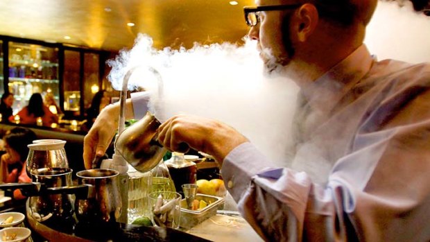 Barry Chalmers prepares liquid nitrogen cocktails for the Nitrogen trolley at the Roosevelt Bar in Sydney.