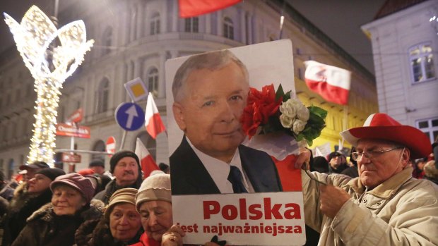 Supporters of the ruling Law and Justice party with a portrait of the leader Jaroslaw Kaczynski.
