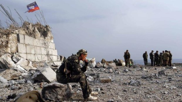 Lonely outpost: A pro-Russian rebel sits at his position in Savur-Mohyla, a hill east of the city of Donetsk.