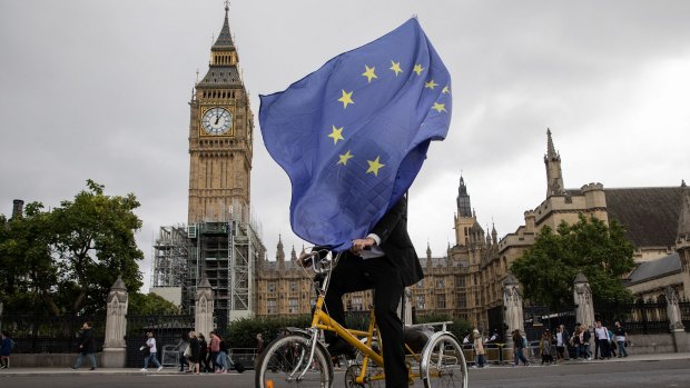 An anti-Brexit demonstrator cycles outside the Houses of Parliament in London. "We are looking at Brexit with interest but not fear," says Macquarie Group chief executive Nic Moore.