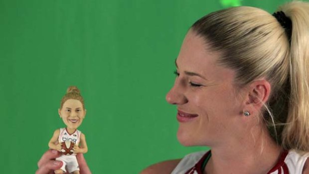 Seattle Storm forward Lauren Jackson smiles at a "bobble head" doll likeness of herself.