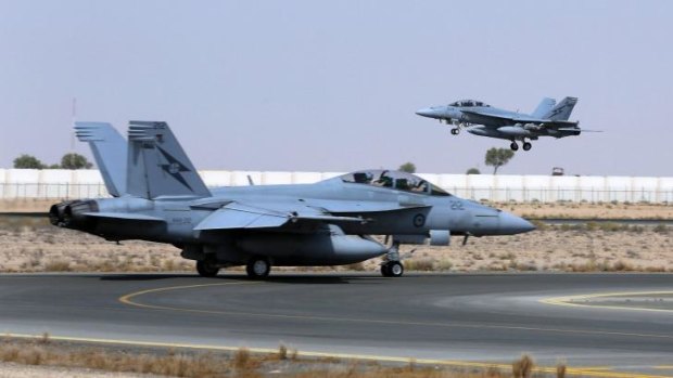 Patrolling northern Iraq ... A Royal Australian Air Force (RAAF) F/A-18F Super Hornet takes off as another taxis along the runway.