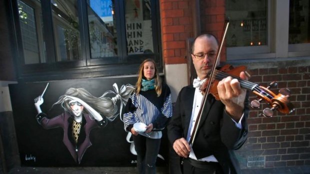Melbourne Symphony Orchestra violinist Roger Young with artist Lucy Lucy outside restaurant Chin Chin on Tuesday.
