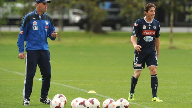Kevin Muscat watches Mark Milligan during training.